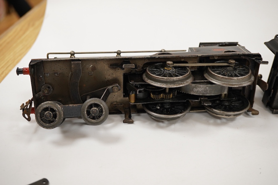 An 0 gauge Bing for Bassett-Lowke tinplate clockwork LNWR 4-4-0 tender locomotive, George the Fifth 2663, in red lined black livery with original clockwork mechanism